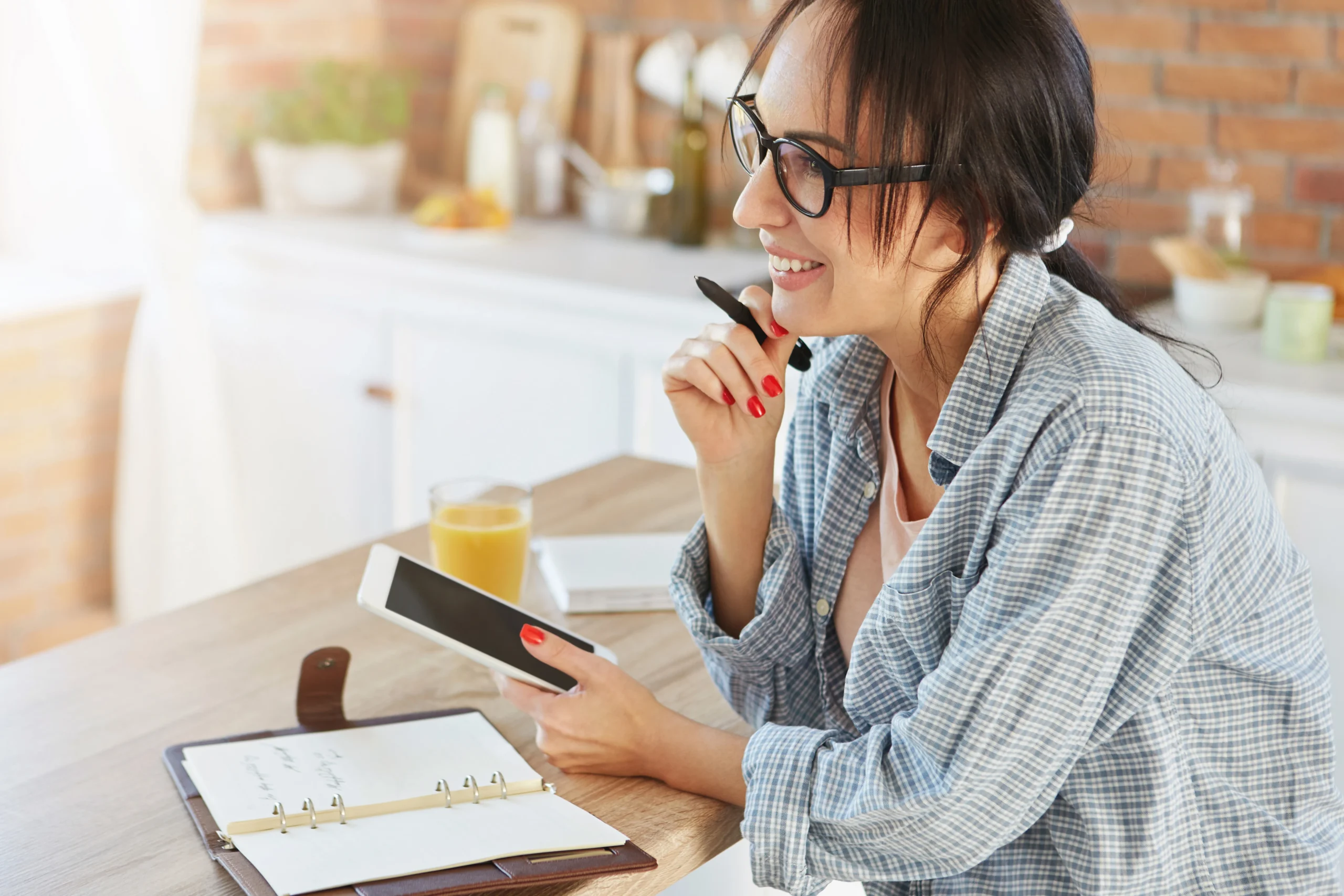 good-looking-brunette-female-being-home-uses-modern-tablet-making-contacts-with-friends-relatives